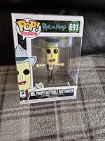 Front view of the boxed Mr. Poopy Butthole Auctioneer Funko Pop figure from Rick and Morty, numbered 691