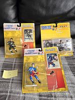 Lot of three NHL Starting Lineup hockey figures in original blister packaging with cards shown, including Brian Leetch, Luc Robitaille, and Daren Puppa.