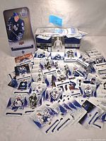 Wide view of the metal tin, scattered hockey cards, die-cuts and the folded banner on a light background