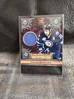 Front of the Panini Crown Royale Lords of the Night jersey card featuring Dustin Byfuglien in Winnipeg Jets uniform and embedded blue jersey patch.