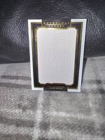 Front view of the Panini Anthology Hockey card featuring Jamie Benn with a white jersey swatch and black and gold border design.