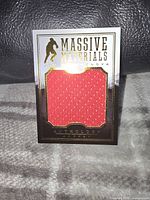 Front of the card showing the large red jersey patch with gold and black accents, 'Massive Materials' title and player name Joe Nieuwendyk.