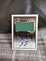 Front of Valeri Nichushkin Panini Anthology card showing green jersey patch and blue autograph signature.