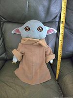 Front view of Baby Yoda plush showing size and details of face and robe
