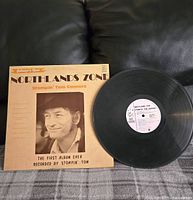 Image shows vintage vinyl record 'Northlands Zone' by Stompin' Tom Connors with original album sleeve featuring artist photo and title.