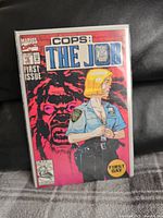 Front cover of the comic book Cops: The Job #1 by Marvel Comics in a protective bag and board.