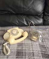 Overview of the vintage Western Electric Princess rotary phone with bagged cords and parts seen next to it.
