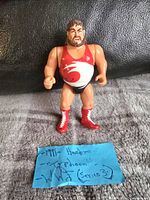 Front view of the 1991 WWF/WWE Typhoon action figure featuring the red singlet with logo, boots and facial details.