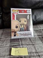 Front view of the Funko Pop figure in its box and protector, showing Stone Cold Steve Austin figure and packaging details including number 84.