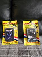 Two WWF/WWE collectible Sports Sounds audio cards featuring The Rock and Undertaker, in original packaging with one card noted as coming away from backing.