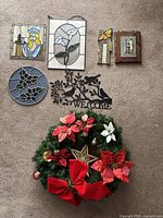 Full lot view showing all stained glass pieces, metal welcome sign, wall decor, and Christmas wreath arranged on carpet.
