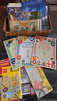 Basket containing multiple vintage and historical maps of UK and Canada including historical maps of Scotland, Ireland, England & Wales, Ontario and city maps.