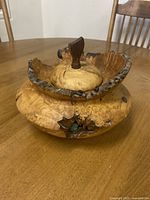 Full view of the handcrafted Alder Burl decorative bowl with natural edge rim and lid on a table.