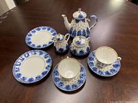 Group shot of porcelain tea service pieces on table