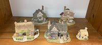All five miniature cottages arranged in a group, showing variety in size and style.