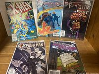 Full set of five Marvel superhero comics displayed: X-Men, two Fantastic Four, two Spider-Man comics, all bagged and boarded.