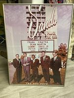 Front view of the framed sepia-toned 'Rat Pack' print showing five men in suits with the Sands marquee in the background.