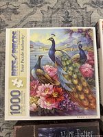 Box of 1000-piece puzzle featuring peacocks next to flowers