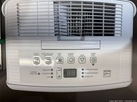 Top view of control panel with buttons, brand logo, and LED display of dehumidifier.