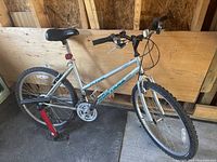 Left-front three-quarter view of entire bicycle against plywood backdrop