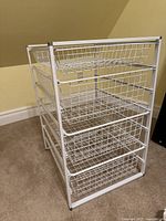 Side view of metal wire storage rack showing four baskets and metal frame.