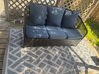 Front view of three seat patio sofa on geometric outdoor rug