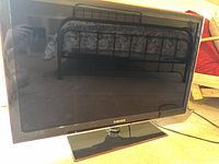Front view of Samsung 40-inch LED television on a rectangular stand with power cable visible.