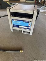 Front view of the hose reel with label showing brand, capacity, and country of manufacture.