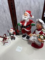 Photo of the set of five Annalee holiday figurines displayed on a table, including Santa, Mrs Claus, and skiing characters.