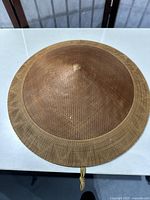 Top view of the conical Patokko hat showing fine bamboo weave with a small peak at the crown.