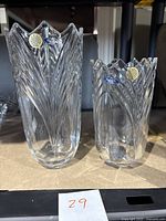 Two clear Bohemia crystal vases, one large and one smaller, both with vertical leaf designs and scalloped edges, showing brand stickers