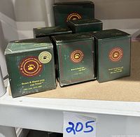 Six unopened green Boyd's Bears Bearstone Collection boxes stacked on shelf, showing the Bearstone logo and text.