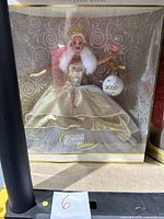 Front view of the Special 2000 Edition Celebration Barbie doll in unopened box showing the doll in gold and silver gown and the 2000 ornament accessory.
