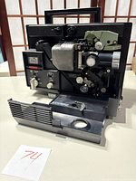 Full view of the Elmo projector showing internal film transport mechanism and front cover removed.