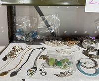 Photo showing assorted bracelets, chain and beaded necklaces, pouches with turquoise beads