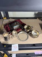 All six sterling pieces on shelf