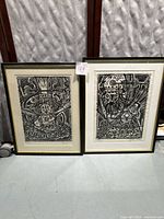 Two framed black and white block prints side by side, Pisces on left, Taurus on right, both signed and numbered by artist.
