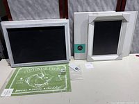 Photo showing two framed chalkboards, one smaller 12x9 inches and a larger Magnolia Co. chalkboard in box 14x20 inches, and a green Cottontail Farms sign.