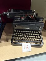 Front view of the Royal typewriter showing round keys and metal body with Royal logo.