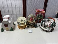 Full lot including two snowglobes, ceramic cookie jar, ice skating rink decoration, and boxed Miss Elle Toe figurine