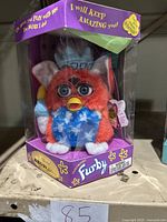 Red white and blue Statue of Liberty themed Furby in original box showing front and side details