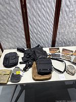 Full lot laid out on white table showing tactical bags, mini organizers, and clips