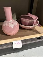 Photo showing all three pottery items including pink casserole dish with lid, serving bowl, and vase