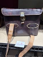 Front view of the vintage Diamond camera bag showing leather straps and metal clasp with visible wear and stitching details.