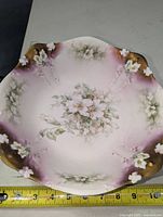 Top view showing detailed clematis floral hand painting with pink gradient background and gold accents on edges.