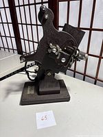 Side view of the Willoscope Senior 16mm film projector showing film feed and lens assembly.