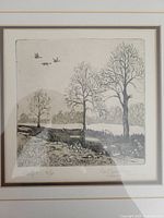 Close-up photo of the etching showing details of the landscape scene, artist signature, and edition number.