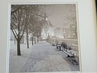 Frontal view of the framed black and white photographic print showing the Chateau Laurier building and snow-covered benches and trees at night.