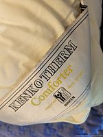 Close-up of the comforter label showing brand and model information.
