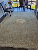Full view of the large carpet in a modern room, showing size and use marks including central circular wear area.